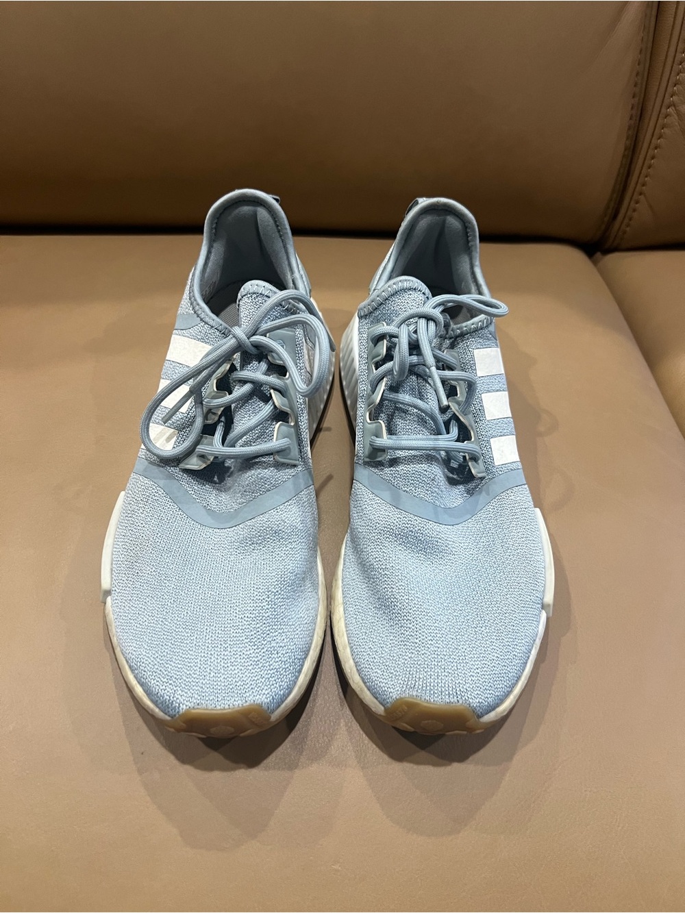 Adidas Light Blue NMD R1 Knit Sneakers with White Stripes.
